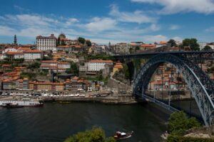 Scenic view of Porto, Portugal featuring the iconic Dom Luís I Bridge over the Douro River.