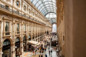 Interior view of Galleria Vittorio Emanuele II in Milan, showcasing its stunning architecture and bustling crowds.