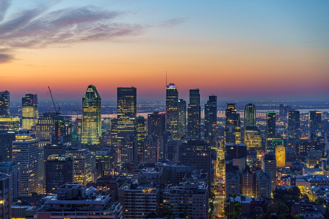 Captivating aerial view of Montreal skyline illuminated at sunset with golden city lights
