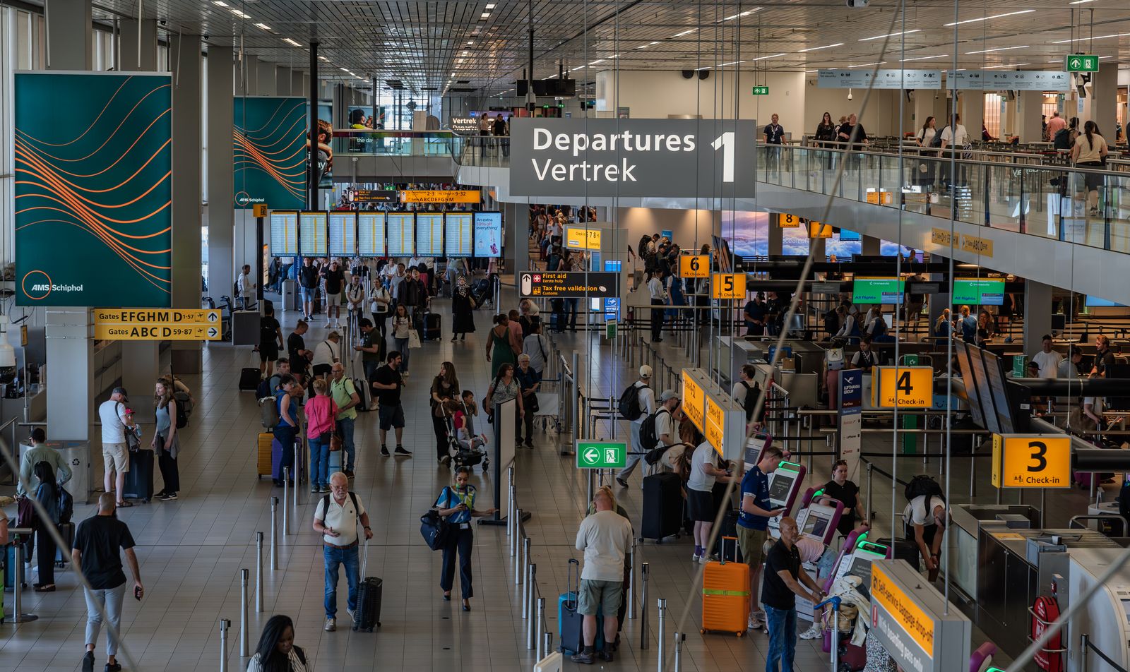 Busy airport departures hall where travelers keep flight details organized in a travel planner app