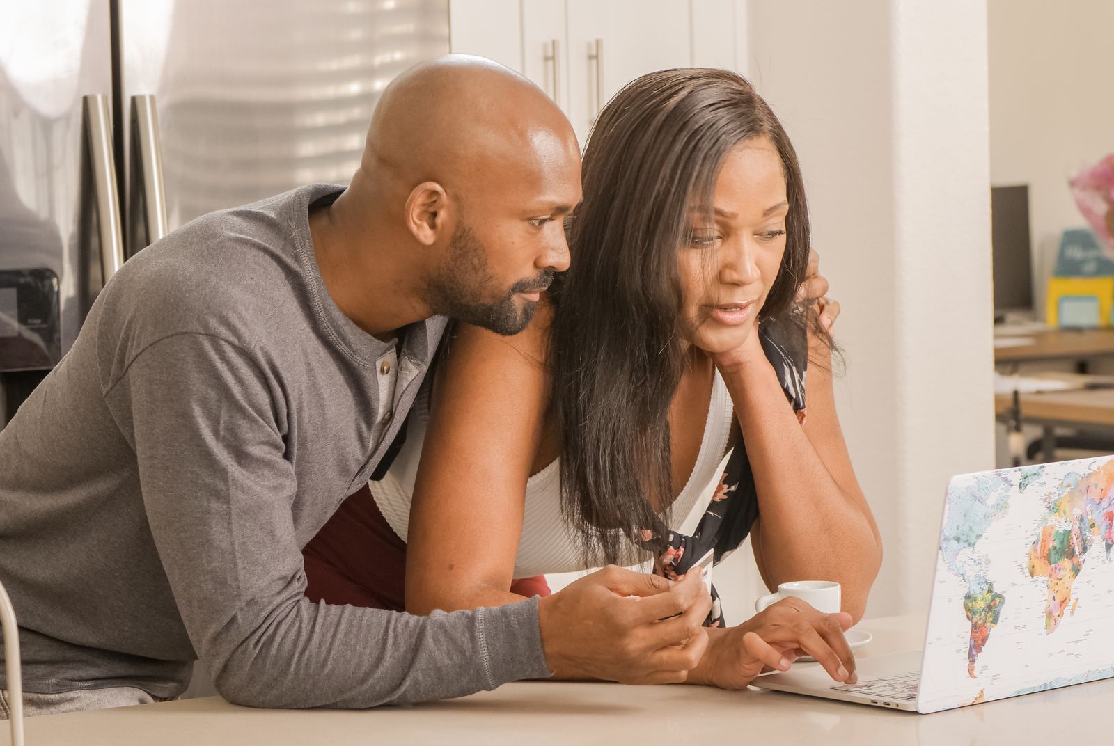 Couple planning a trip together on a laptop, organizing their travel with the Stamped travel planner app