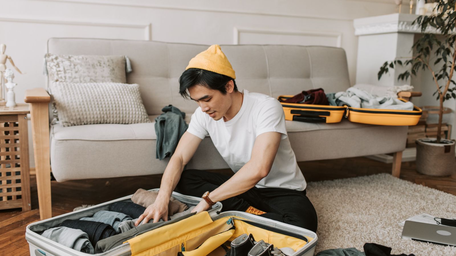 Open suitcase being packed with clothes and travel essentials from a packing checklist