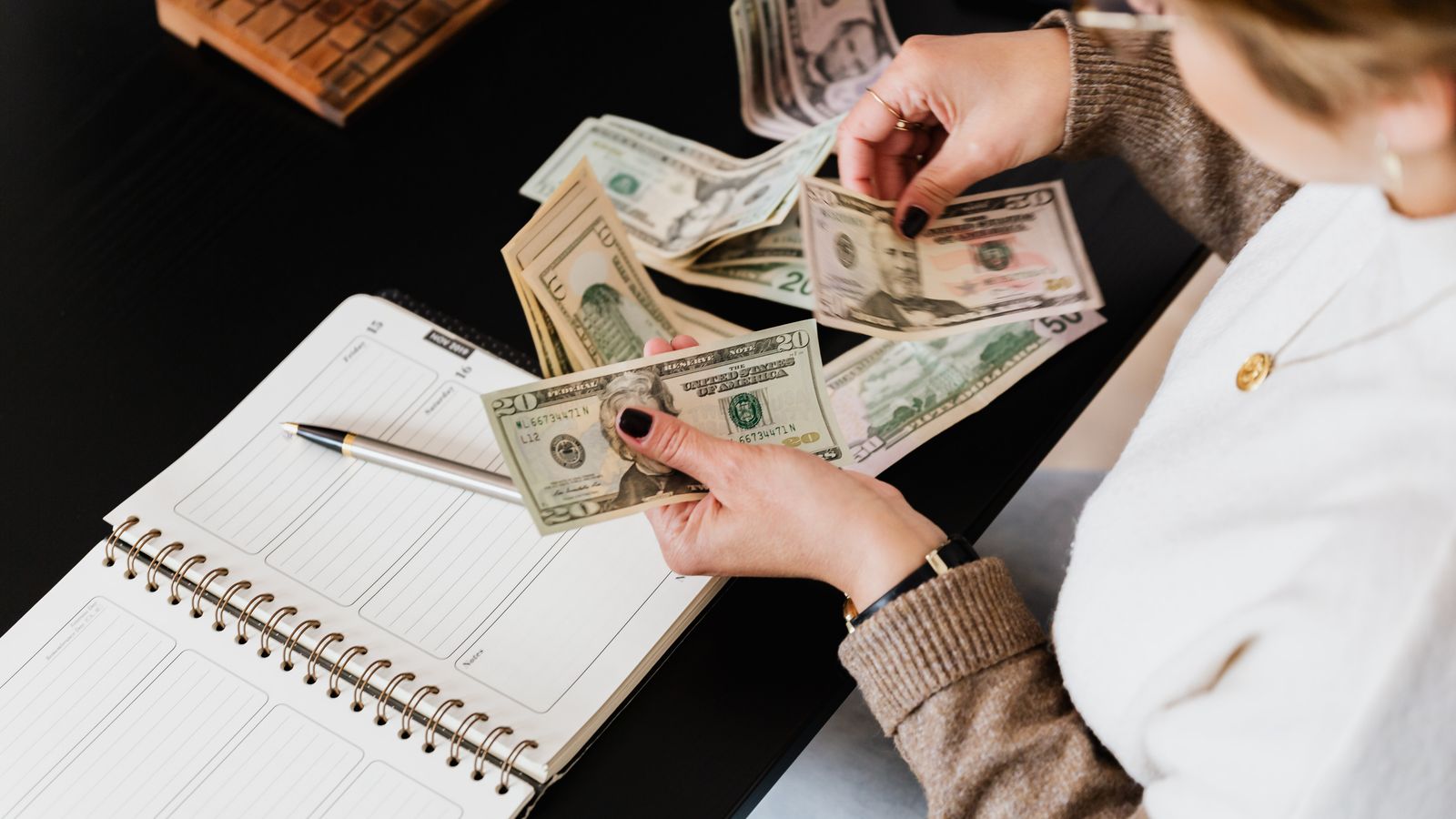 Cash, calculator and receipts used to track a travel budget before and during a trip