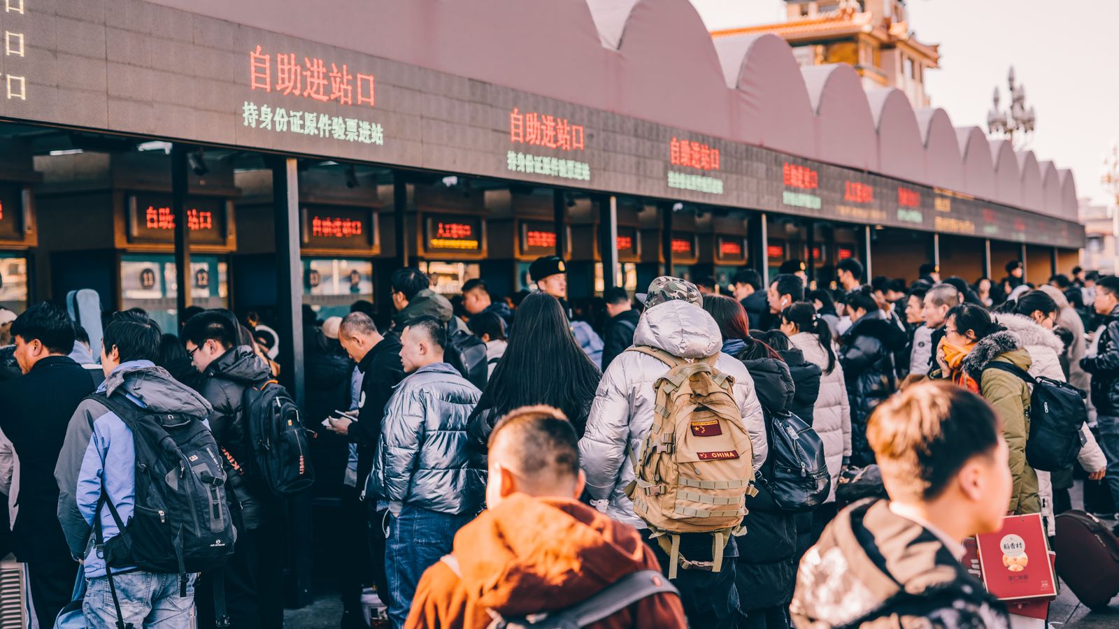 Long queue of tourists waiting in line at an attraction ticket window