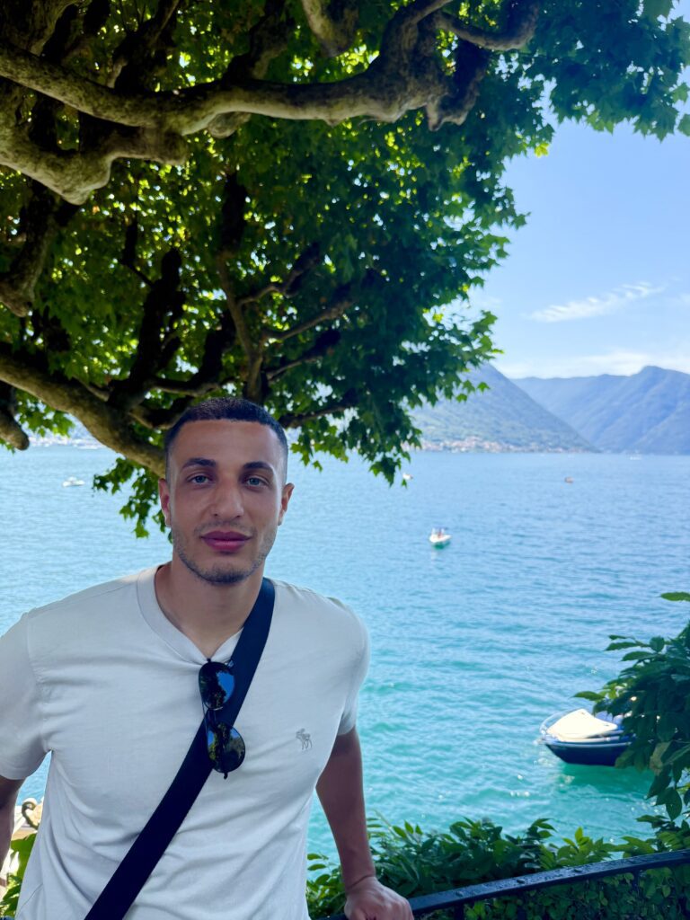 Ryan Radwan traveling beside a mountain lake