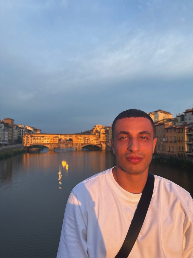 Ryan Radwan beside the Arno River and Ponte Vecchio in Florence