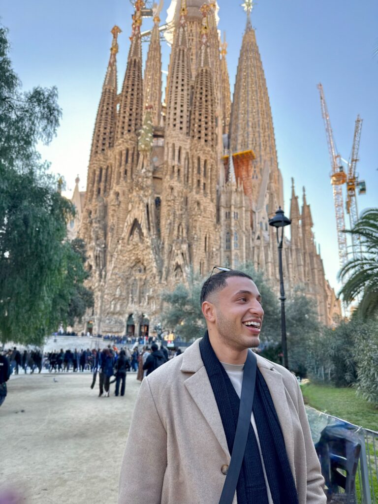 Ryan smiling in front of the Sagrada Família in Barcelona