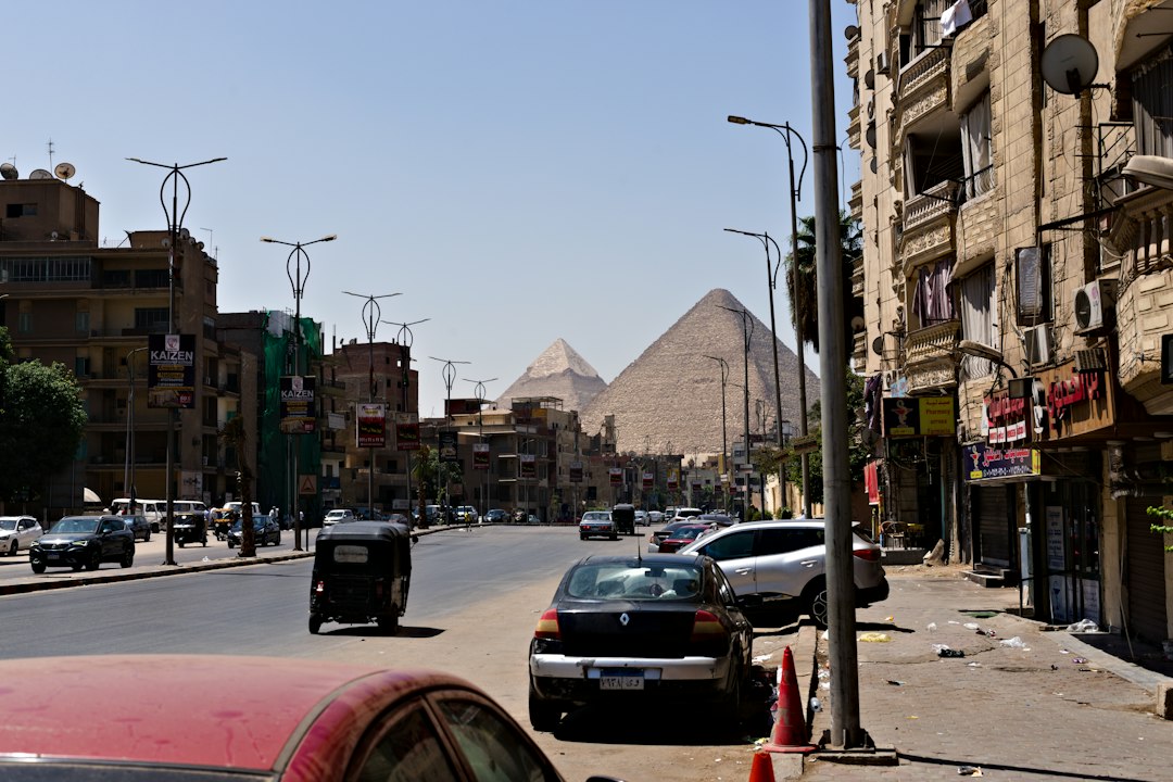 The pyramids rising above Giza street traffic and buildings